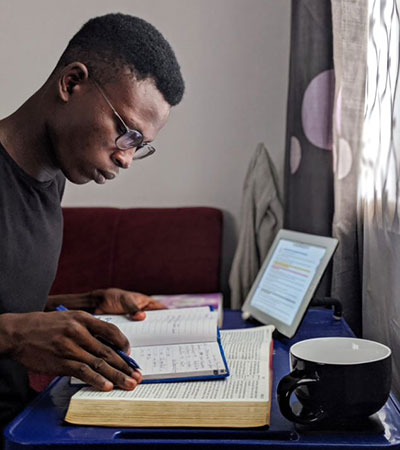Young man studying his Bible and notes image